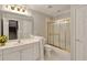 Clean bathroom featuring white vanity, gold-framed shower, and good lighting at 2250 Edgemere Lake Cir, Marietta, GA 30062