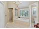 Bright bathroom features a soaking tub, step-in shower with gold trim, a window and a toilet room at 2250 Edgemere Lake Cir, Marietta, GA 30062