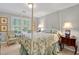 Charming bedroom featuring shuttered windows, sitting area, four-poster bed, and side tables at 2250 Edgemere Lake Cir, Marietta, GA 30062