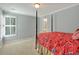Bright bedroom featuring a four-poster bed, neutral walls, and access to an en-suite bathroom at 2250 Edgemere Lake Cir, Marietta, GA 30062