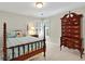 Bedroom featuring shuttered windows, an ornate dresser, a four-poster bed, and neutral walls at 2250 Edgemere Lake Cir, Marietta, GA 30062