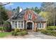Charming brick home with a stylish front entrance, complemented by well-manicured landscaping at 2250 Edgemere Lake Cir, Marietta, GA 30062