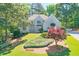 Stunning home with manicured lawn, lush landscaping, and mature trees at 2250 Edgemere Lake Cir, Marietta, GA 30062