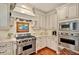 Well-equipped kitchen features a stainless steel Viking range, double oven, and custom cabinetry with updated hardware at 2250 Edgemere Lake Cir, Marietta, GA 30062