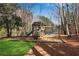 This backyard features a fun playground with a slide and swings, perfect for outdoor play at 2250 Edgemere Lake Cir, Marietta, GA 30062
