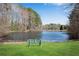 A serene pond view with lush green grass and a peaceful bench, perfect for relaxation at 2250 Edgemere Lake Cir, Marietta, GA 30062