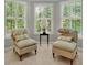Bright sitting area with two plush chairs featuring lots of natural light from bay windows with plantation shutters at 2250 Edgemere Lake Cir, Marietta, GA 30062