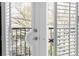Balcony with white shutters and wrought iron railing overlooking mature trees and landscaping at 2255 Peachtree Ne Rd # 521, Atlanta, GA 30309