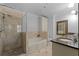Bathroom featuring stone-look tile shower and flooring, soaking tub, and single sink vanity with granite counter at 2255 Peachtree Ne Rd # 521, Atlanta, GA 30309