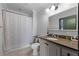 Updated bathroom featuring a single sink vanity with granite countertop, tile floors, and a shower and tub at 2255 Peachtree Ne Rd # 521, Atlanta, GA 30309