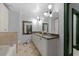 Bathroom featuring double sink vanity with granite countertop, stone-look tile floors, tub, and shower at 2255 Peachtree Ne Rd # 521, Atlanta, GA 30309