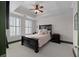Bedroom with tray ceilings, black wood furniture, plush carpet, and white plantation shutters at 2255 Peachtree Ne Rd # 521, Atlanta, GA 30309