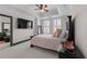 Comfortable bedroom with black furniture, plantation shutters, and a view of the living area at 2255 Peachtree Ne Rd # 521, Atlanta, GA 30309