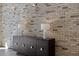 Hallway featuring a decorative brick wall, tiled flooring, and elegant lighting fixtures at 2255 Peachtree Ne Rd # 521, Atlanta, GA 30309
