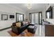 Bright living room featuring a leather sectional, colorful rug, white walls, and bright white tile flooring at 2255 Peachtree Ne Rd # 521, Atlanta, GA 30309