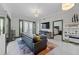 Bright living room featuring elegant lighting fixtures, doors to the patio, and an open doorway to the bedroom at 2255 Peachtree Ne Rd # 521, Atlanta, GA 30309