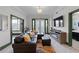 Cozy living room with a black leather sofa, electric fireplace, and decorative rug at 2255 Peachtree Ne Rd # 521, Atlanta, GA 30309
