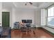 This office features a ceiling fan, hardwood flooring, window with shutter, and dark green painted trim at 2255 Peachtree Ne Rd # 521, Atlanta, GA 30309