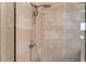 Close up on the stone-look tile in the primary bath's shower, featuring dual shower heads at 2255 Peachtree Ne Rd # 521, Atlanta, GA 30309