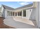 Wide concrete patio and backyard featuring modern home design at 309 Sassafras Way, Holly Springs, GA 30115