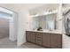 Bathroom featuring a double sink vanity and a walk-in shower at 309 Sassafras Way, Holly Springs, GA 30115