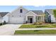 Charming single-Gathering home featuring a well-manicured lawn, a two-car garage, and a welcoming front porch at 309 Sassafras Way, Holly Springs, GA 30115