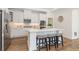Beautiful kitchen with white cabinets, stainless steel appliances, and an island with seating at 309 Sassafras Way, Holly Springs, GA 30115