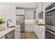 Bright kitchen featuring stainless steel appliances, a gas range and a kitchen island with a sink at 309 Sassafras Way, Holly Springs, GA 30115