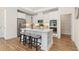 Modern kitchen featuring stainless steel appliances, a center island, and ample cabinet space with sleek countertops at 309 Sassafras Way, Holly Springs, GA 30115