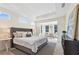 Spacious bedroom featuring an en-suite sitting area and tray ceiling at 309 Sassafras Way, Holly Springs, GA 30115