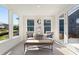 Bright sitting room with natural light, comfortable seating, and access to the outdoors at 309 Sassafras Way, Holly Springs, GA 30115