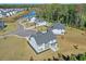 Stunning aerial view capturing contemporary homes nestled in a community near a serene pond and lush trees at 3440 Carswell Bnd, Cumming, GA 30028