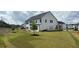 Expansive backyard featuring a lush lawn and complemented by the home's classic white exterior at 3440 Carswell Bnd, Cumming, GA 30028