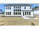 Backyard showcasing a modern home with multiple windows and an outdoor patio perfect for entertaining at 3440 Carswell Bnd, Cumming, GA 30028