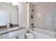 A bathroom featuring a vanity, a toilet, and a tiled bathtub shower with a tile niche for bath supplies at 3440 Carswell Bnd, Cumming, GA 30028