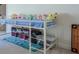 A bedroom featuring a unique lofted bed frame, built-in storage and shelving for books and toys, and blue area rug at 3440 Carswell Bnd, Cumming, GA 30028