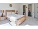 Bright bedroom with a wooden bed frame, side tables and an ensuite bathroom at 3440 Carswell Bnd, Cumming, GA 30028