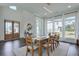 Bright dining room with wood floors features a long wooden table and big windows letting in natural light at 3440 Carswell Bnd, Cumming, GA 30028