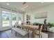 Bright dining room features a wooden table with bench seating and large windows offering abundant natural light at 3440 Carswell Bnd, Cumming, GA 30028