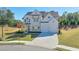 Picture of a two-story home with a well-manicured lawn, long driveway, and landscaping at 3440 Carswell Bnd, Cumming, GA 30028