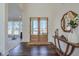 Spacious foyer with hardwood floors, double glass doors, and views of the living spaces at 3440 Carswell Bnd, Cumming, GA 30028