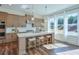 Charming kitchen with center island, breakfast bar, stainless appliances, and natural light from large windows at 3440 Carswell Bnd, Cumming, GA 30028