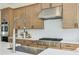 Close-up of modern kitchen featuring stainless steel appliances, light wood cabinets, and white countertops at 3440 Carswell Bnd, Cumming, GA 30028
