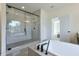 A main bathroom featuring a bathtub, a glass-door shower, and an open door to the bedroom with carpeted floors at 3440 Carswell Bnd, Cumming, GA 30028