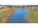Scenic view of the community pond with natural surroundings and lush greenery at 3440 Carswell Bnd, Cumming, GA 30028