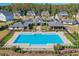 Community pool with a clubhouse and well-maintained landscaping, ideal for relaxation at 3440 Carswell Bnd, Cumming, GA 30028