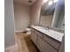 This bathroom has a vanity with granite countertops, mirror and single sink at 1015 Crest Ridge Sw Pl, Marietta, GA 30060