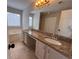 Bathroom featuring double sinks with granite countertop and a large soaking tub at 1015 Crest Ridge Sw Pl, Marietta, GA 30060