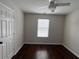 Bright bedroom featuring hardwood floors, window, and ceiling fan at 1015 Crest Ridge Sw Pl, Marietta, GA 30060
