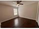This cozy bedroom features a ceiling fan, window and hardwood flooring at 1015 Crest Ridge Sw Pl, Marietta, GA 30060
